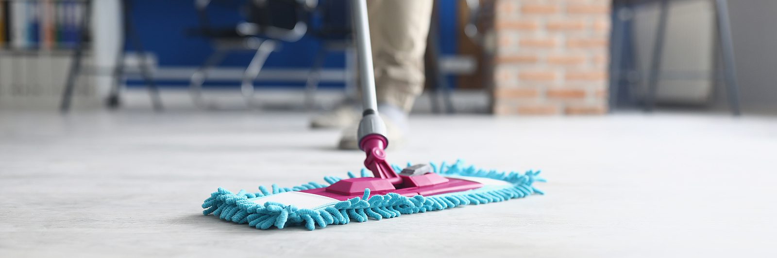 close up photo of a floor mop, cleaning service cleaning a classroom