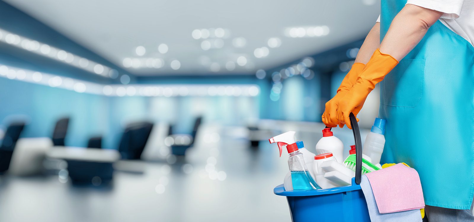 cleaning service professional holding a bucket of cleaning supplies