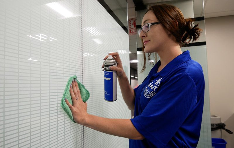 quality cleaning services employee cleaning glass